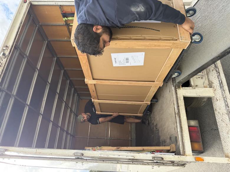 Movers delivering a furniture crate